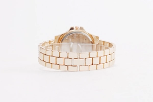 Detailed back view of rose gold metal watch strap with classic folding clasp closure