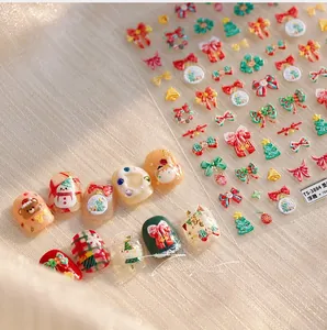 Detailed macro view of 5D embossed Christmas nail art stickers with snowman and bows