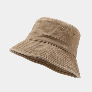 Detailed texture of washed canvas bucket hat featuring breathable eyelets and wide brim