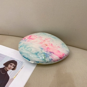 Detail view of the pink and blue watercolor marble texture on the oval acrylic clutch bag