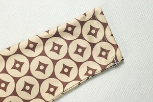 Detail of slim fit long sleeve cuff with geometric print and precise stitching