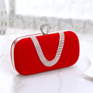 Detail of red velvet evening bag with sparkling silver rhinestone chain and crystal ring closure