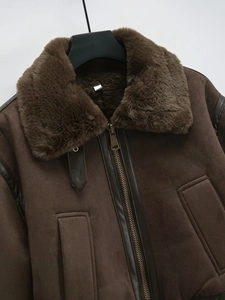 Detailed view of brown faux shearling aviator jacket featuring plush collar and metal zipper