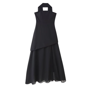 Detail of black halter maxi dress showing asymmetrical layered skirt with mesh material