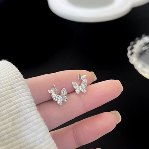 Macro shot of S925 sterling silver butterfly stud earrings with sparkling crystals