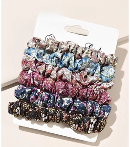 Detail of 6-pack floral fabric scrunchies in various pastel colors on a display card