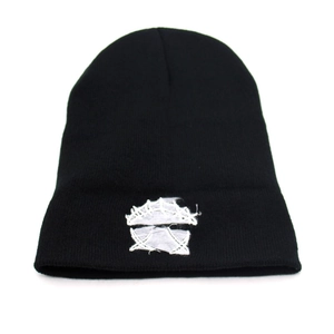 Black knitted beanie hat with white abstract graphic embroidery for autumn outdoor warmth