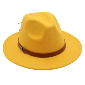 Detail of yellow wool fedora hat featuring a brown leather band and silver buckle