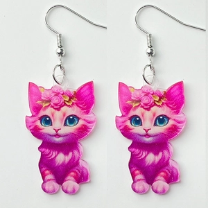 Detailed view of pink acrylic cat earrings with blue eyes and silver fishhook wires