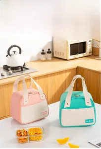 Detail of insulated lunch bag with Tasty Food logo and sturdy handles in a modern kitchen