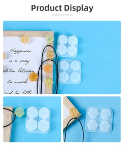 Detailed view of 4-cavity mini cat paw silicone mold with finished resin pendants