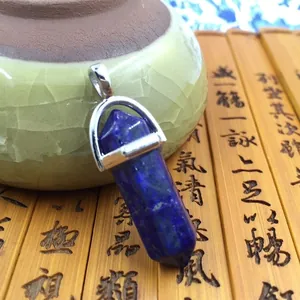 Lapis Lazuli hexagonal pillar pendant with silver metal bail on bamboo background