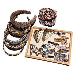 Leopard print hair accessory set with headbands, scrunchies and clips on white background