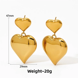 Detailed view of hollow gold heart drop earrings with dimensions 47mm height and 29mm width