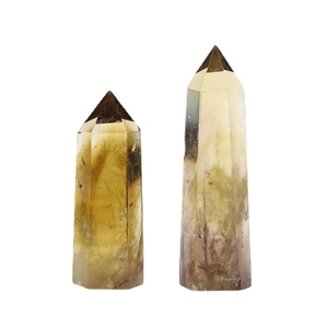 Natural Brazilian citrine crystal columns in different heights on a white background