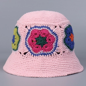 Close-up of pink hand-crocheted bucket hat showing colorful floral knit texture