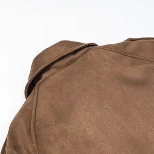 Close-up of shoulder seam and lapel detail on a long brown faux suede trench coat
