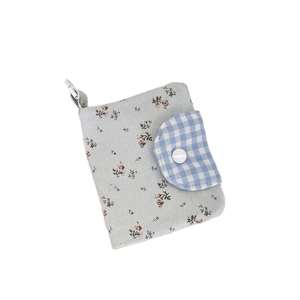 Floral fabric coin purse with blue check flap and white carabiner hook on white background