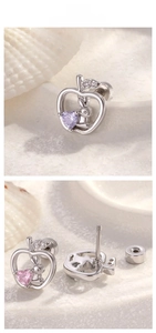 Detail of apple-shaped ear stud with a heart zircon and secure screw-back closure