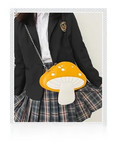 Detail of cute yellow mushroom crossbody bag styled with JK uniform and silver chain