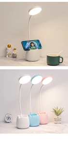 Detail view of flexible white neck LED desk lamp with pen holder and phone stand base