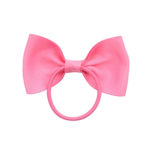 Close-up of pink grosgrain ribbon bow hair tie with high-elastic band on white background
