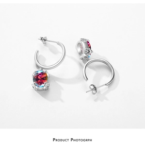 Macro shot of S925 sterling silver hoop earrings with iridescent pink round cut gemstones
