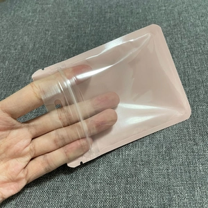 Detail of a pink self-sealing plastic packaging bag with zipper and hanging hole