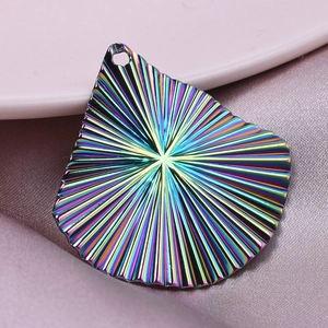 Detail of 304 stainless steel fan-shaped charm with rainbow electroplating and radial texture