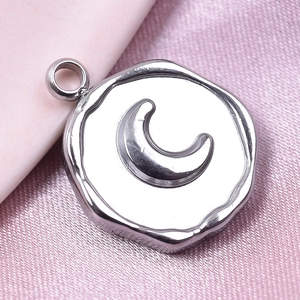 Close-up of a silver stainless steel irregular round pendant featuring an embossed moon