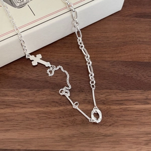 Minimalist 925 sterling silver necklace with cross pendant on rustic wood surface