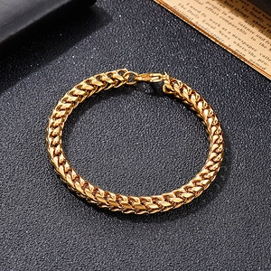 Detailed top view of gold-tone dragon bone titanium steel chain bracelet with lobster clasp