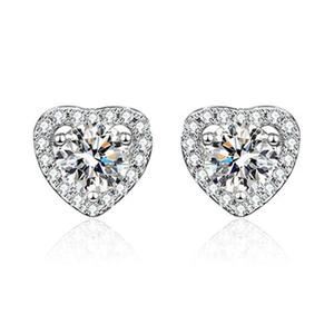 Macro view of heart-shaped halo stud earrings with silver plating and sparkling stones