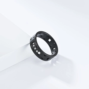 Detail of black stainless steel ring featuring hollow grid design and three small crystals