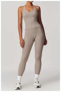 Full view of grey-brown cross back yoga vest and high-waisted leggings set on model