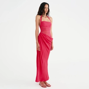 Detail of pink halter neck satin dress with elegant pleats and backless design