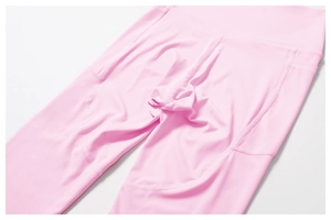 Detail of pink high-waisted yoga pants with flatlock seams and functional stitching