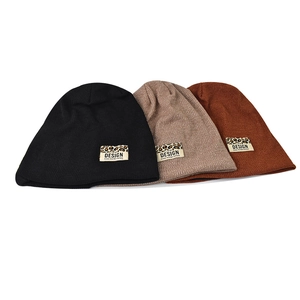 Winter knit beanies in black, coffee, and rust red with leopard print design patches