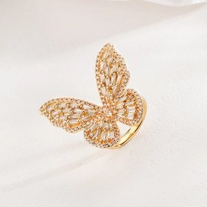 Elegant gold butterfly ring with sparkling cubic zirconia on a minimalist background