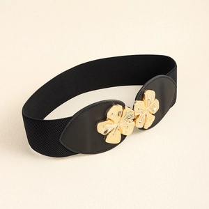 Detail of elegant black elastic waist belt with golden floral metal buckle for women