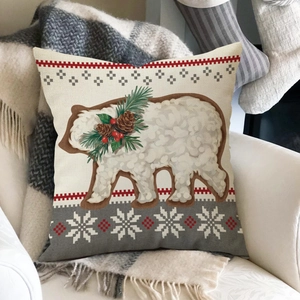 Detail of Christmas bear throw pillow case with linen texture on a cozy sofa