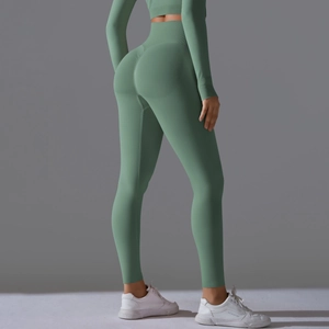 Detail of high-waisted light green seamless yoga pants with back ruched butt lifting design