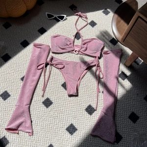 Detail of pink glitter bikini set including halter top and matching flare sleeves