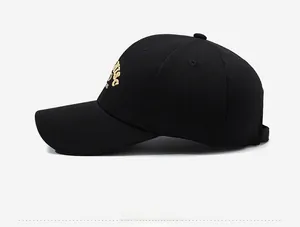 Side view of black baseball cap with premium gold 3D embroidery and textured fabric detail