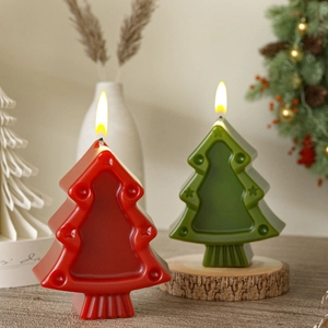 Detailed view of red and green Christmas tree candles on a rustic wooden base decoration