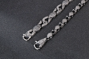 Detail of vintage silver titanium steel chain bracelet with embossed geometric patterns