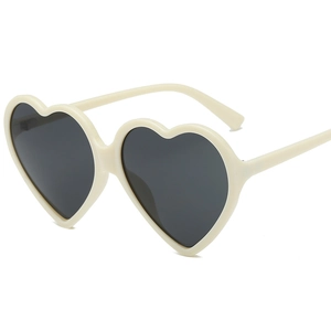 Fashionable heart-shaped cream white sunglasses with black lenses shown from a 45-degree angle