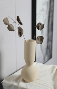 Detailed close-up of spiral texture on Nordic ceramic vase with dried eucalyptus