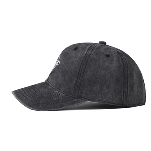 Close-up of embroidery details and washed cotton fabric on distressed turtle baseball cap