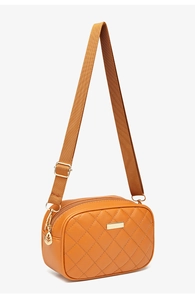 Detail of yellow quilted crossbody bag with adjustable canvas strap and gold hardware